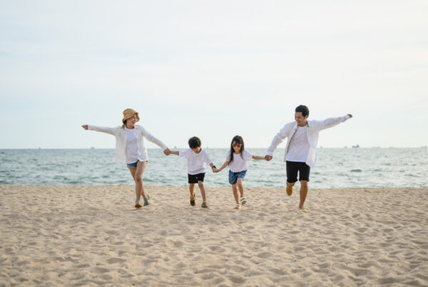 Happy family father mother daughter and son spending vacation time together on beach, Family with beach travel, Happy Asian family travel together on beach on holiday, Family with beach travel